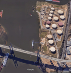 A satellite image of the above ground oil storage tank farm at Magazine Point in Africatown with the Africatown Bridge in the foreground.